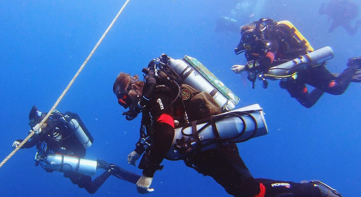 Three DJL tech divers with CCR units descending a line.